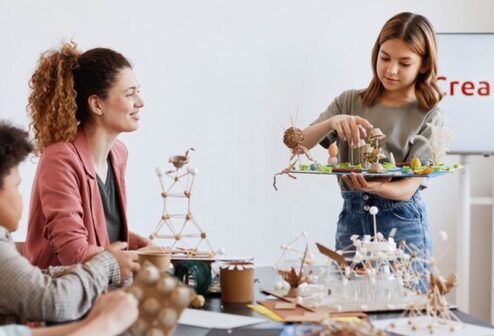 portrait-teen-girl-presenting-school-project-class-art-craft-lesson-school_236854-31862